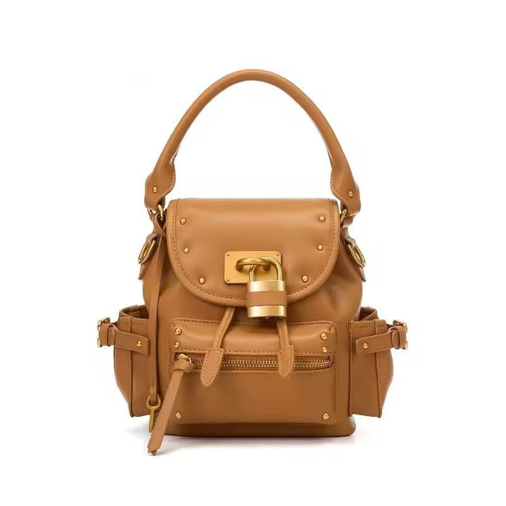 Namrico studded leather shoulder bag close-up of oversized gold padlock clasp on flap
