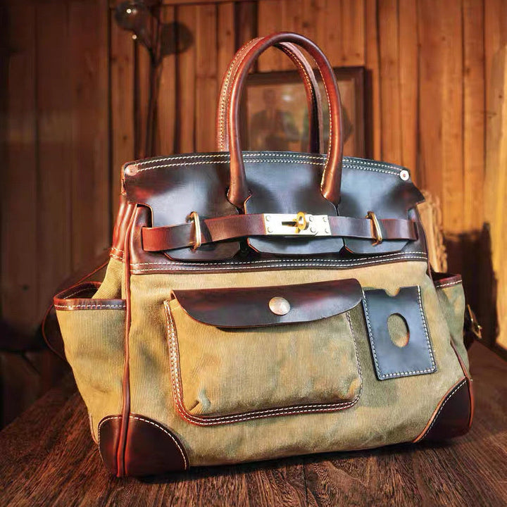 Waxed canvas bag with leather accents on a wooden surface