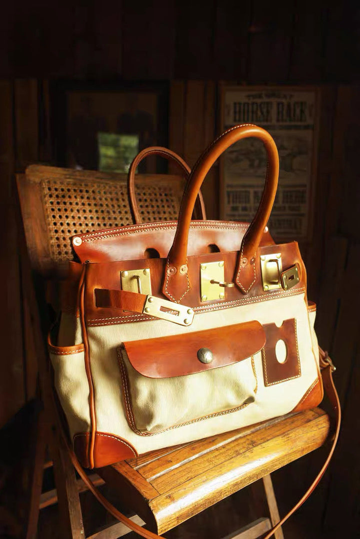 Brown and beige handbag on a wooden stool with a dark background