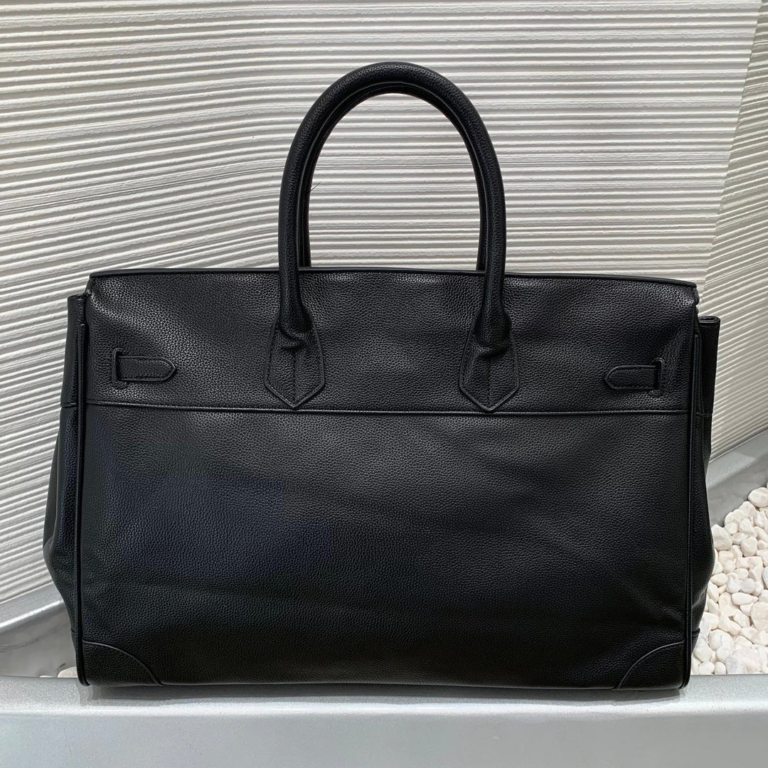 Black leather handbag on a light gray background