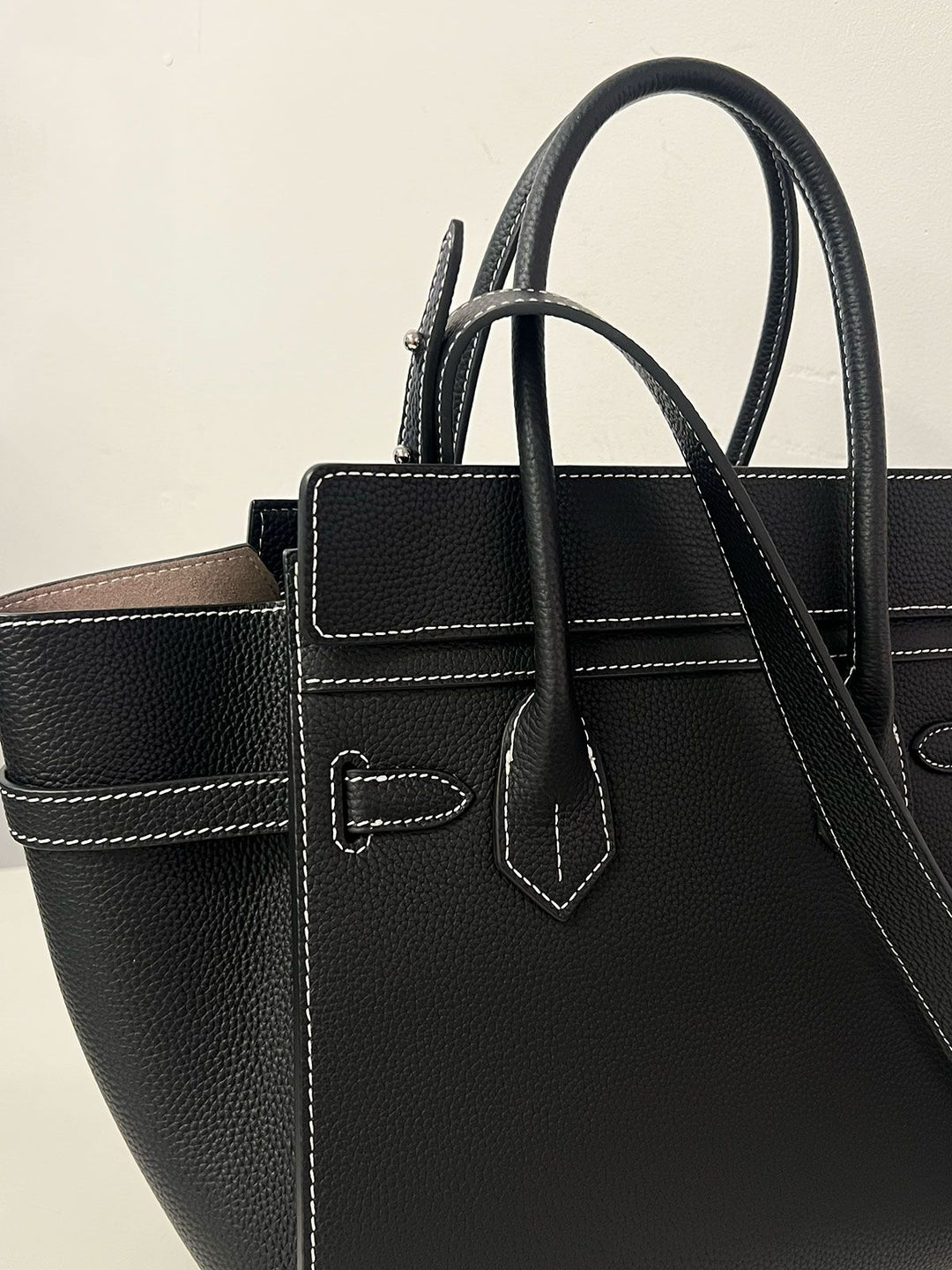 Luxury artisan woven raffia tote bag bronze hardware close up detail