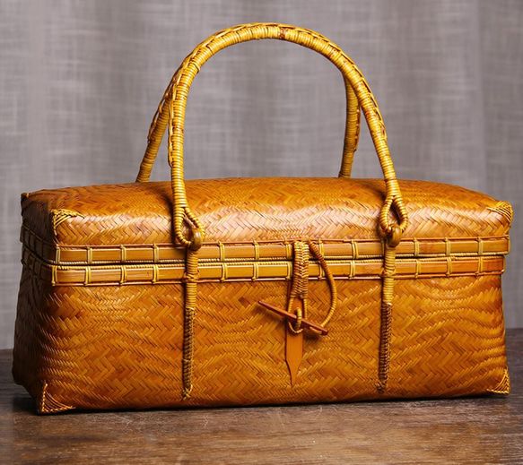 Artisan bamboo bag close up detail showing herringbone weave texture and handles