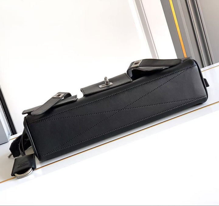 Black briefcase on a white surface with a blurred background