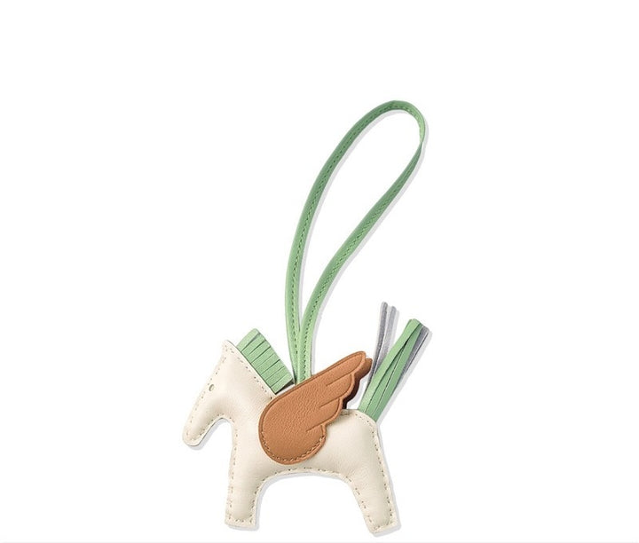 Small horse-shaped keychain with a green strap on a white background