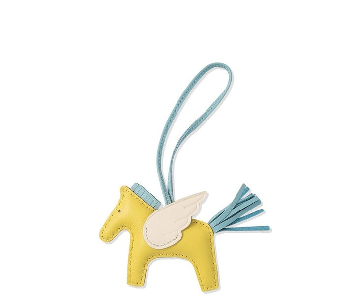 Yellow horse-shaped keychain with blue strap on a white background