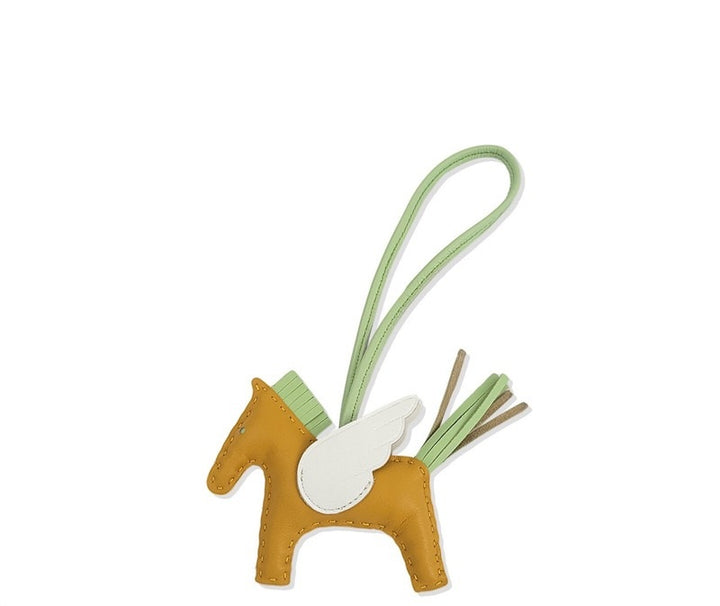 Horse-shaped keychain with a green strap on a white background