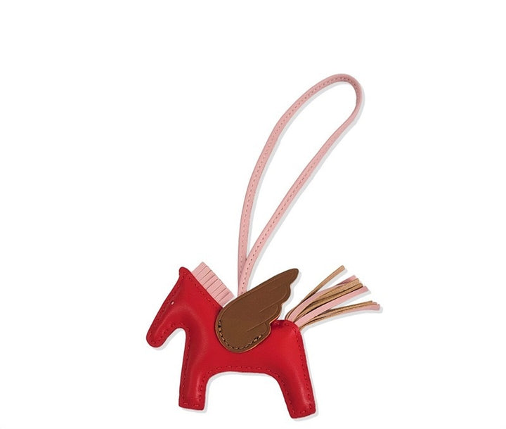 Red horse-shaped keychain with a pink strap on a white background