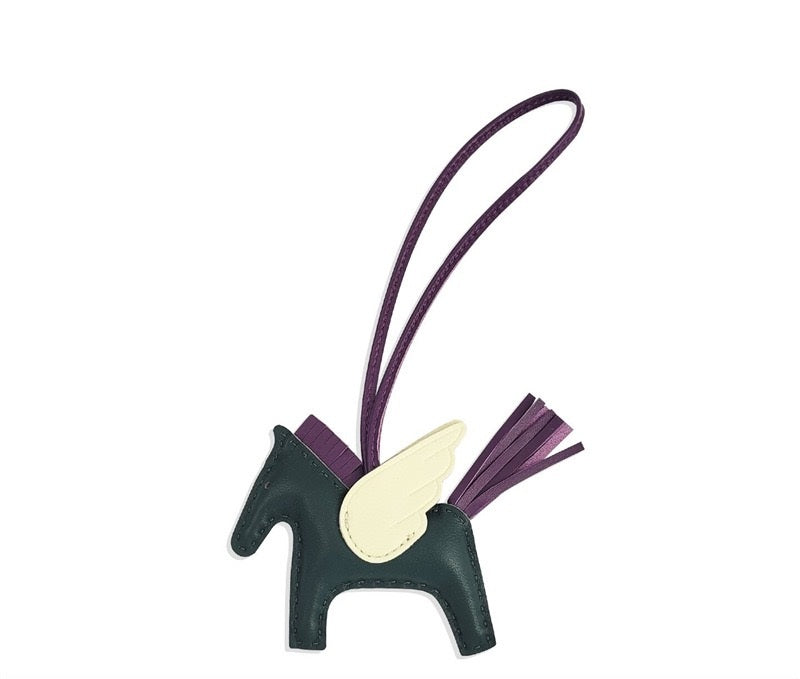 Unicorn-shaped keychain with a strap on a white background