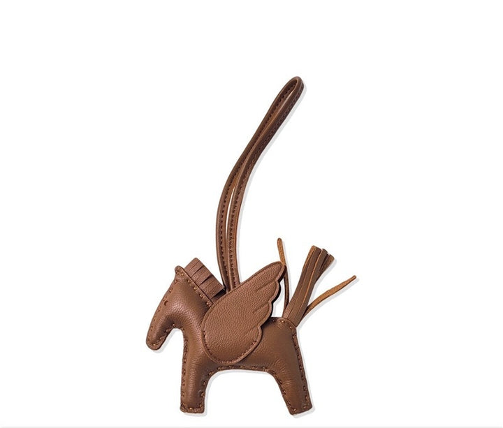 Brown leather keychain shaped like a horse on a white background