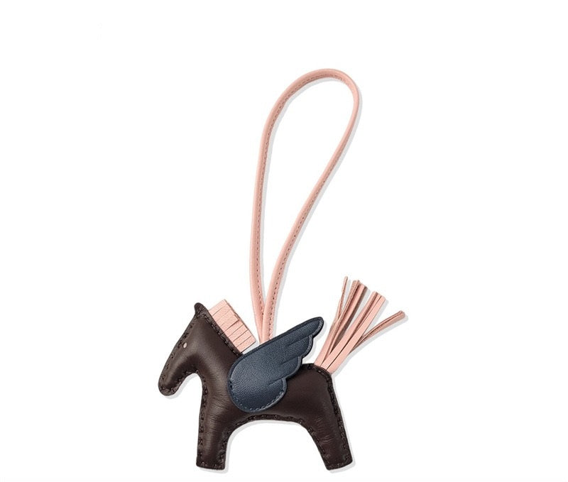 Brown horse-shaped keychain with pink accents on a white background