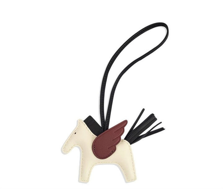 Horse-shaped keychain with a black strap and red saddle on a white background