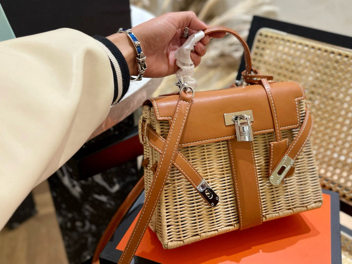 Brown handbag with wicker design held by a person, with a blurred background