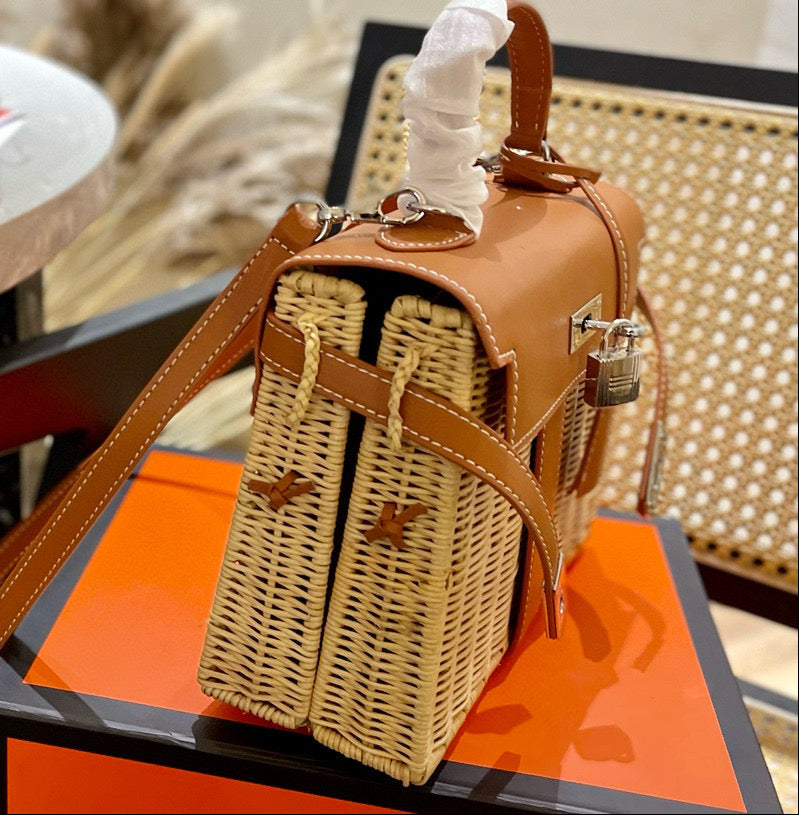 Brown handbag with woven pattern on an orange surface