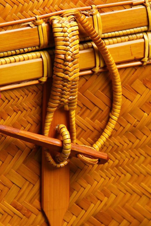 Compact bamboo artisan bag with rope tie closure and braided bamboo handles