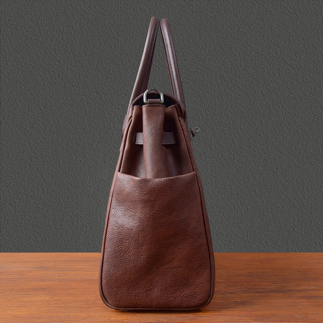 Brown pebbled leather artisan work bag with silver hardware and shoulder strap
