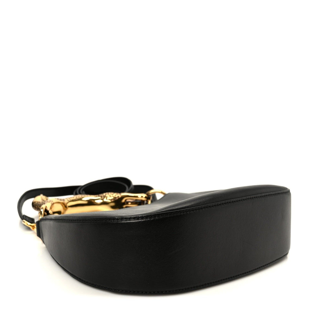 Black leather belt with gold buckle on a white background
