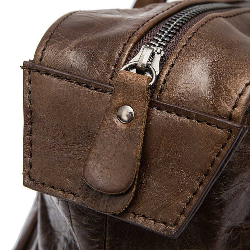 Distressed brown leather travel bag with buckle