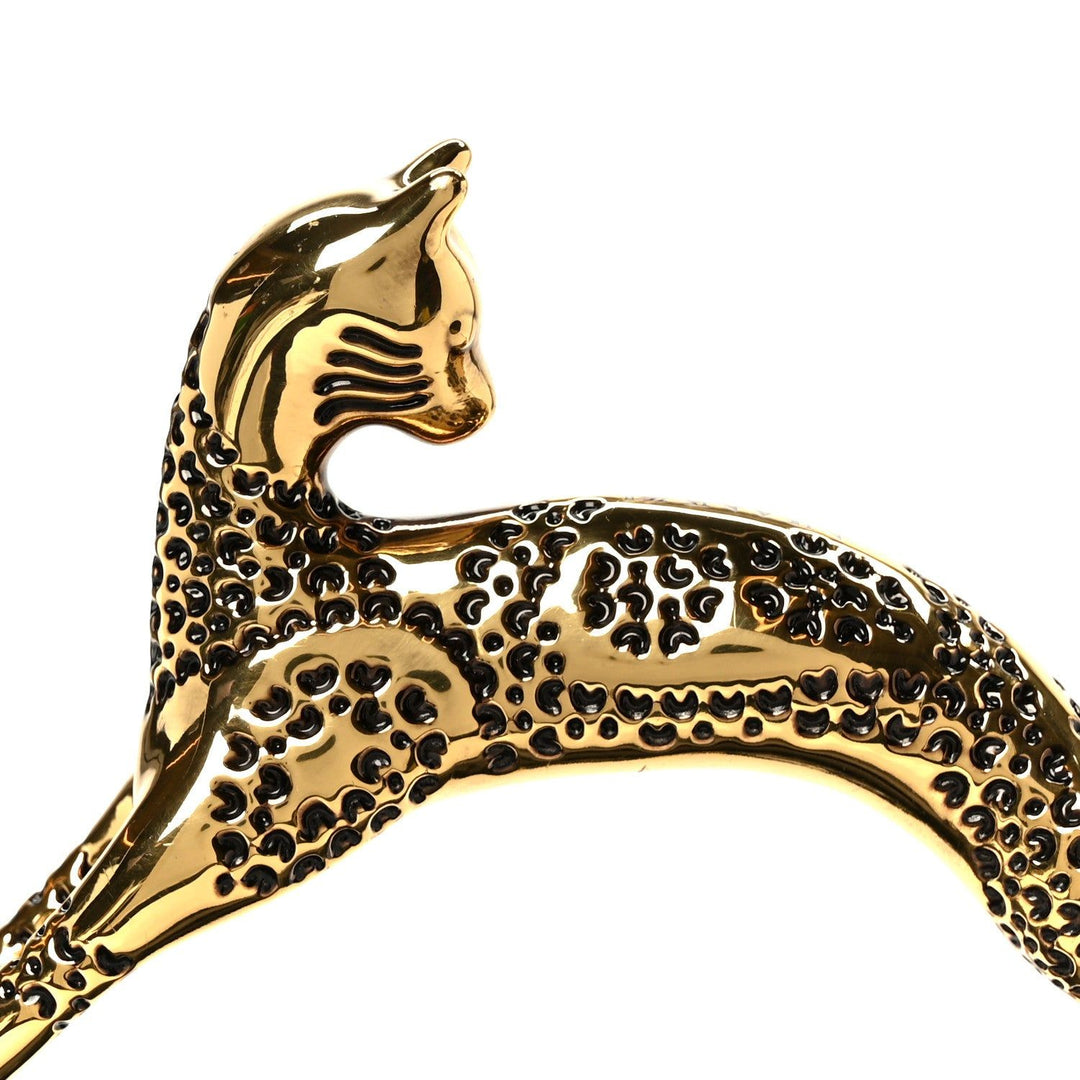 Gold panther-shaped brooch on a white background