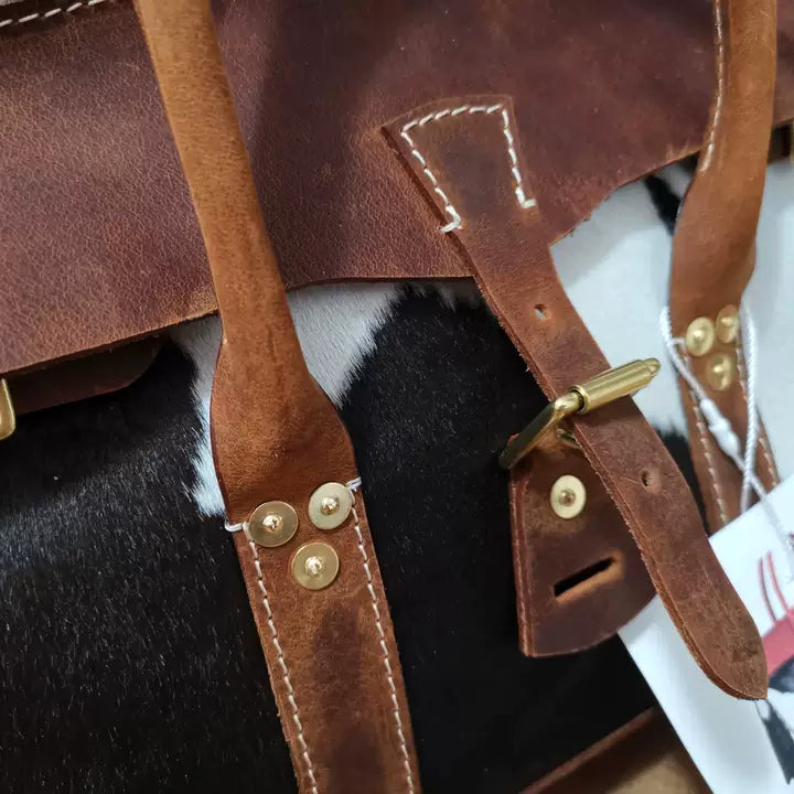 Luxury cowhide travel bag with tan leather straps