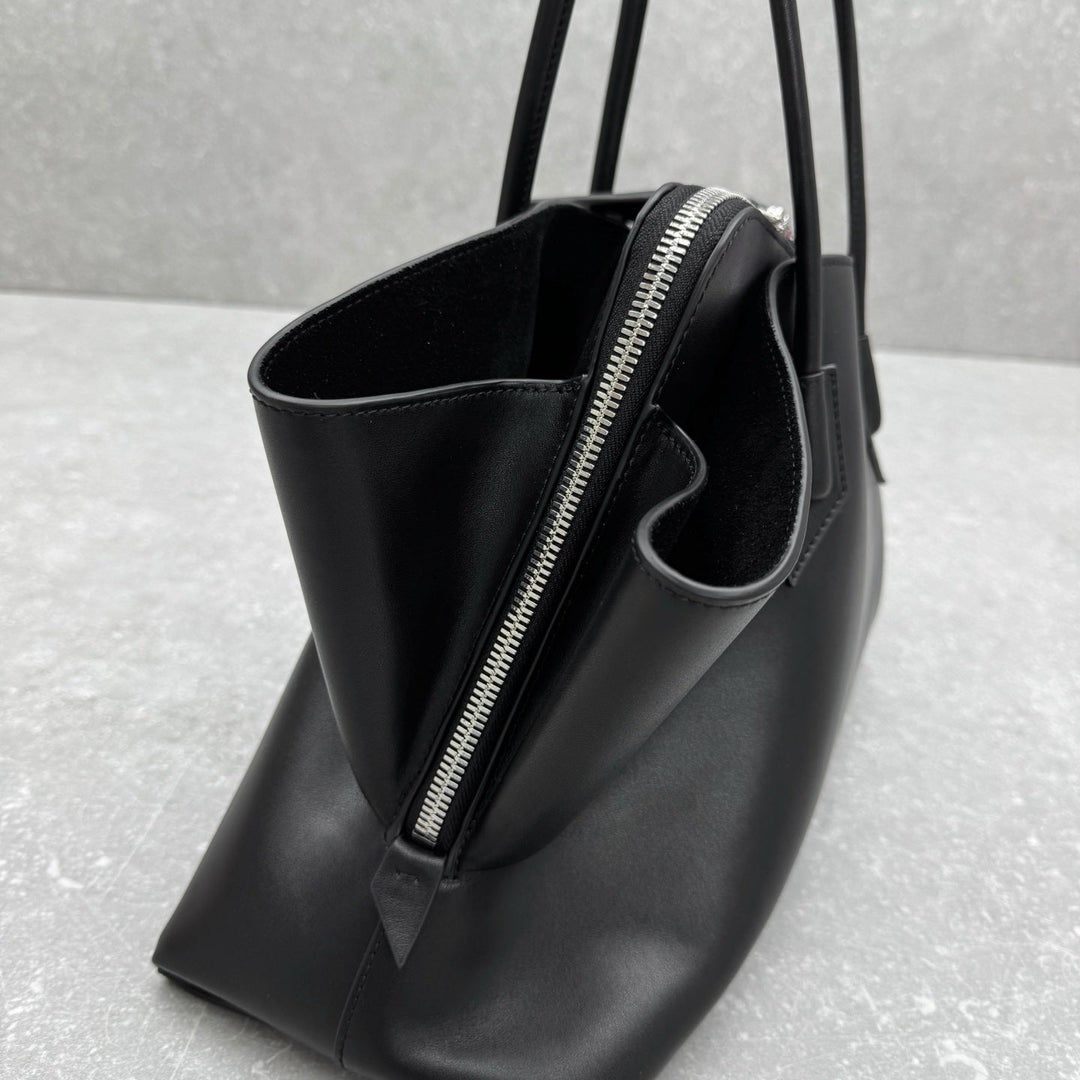 Minimalist black leather tote with zip top