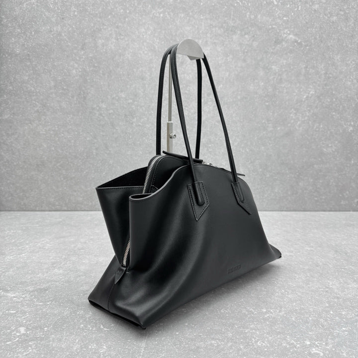 Sleek black leather arc shaped shoulder tote