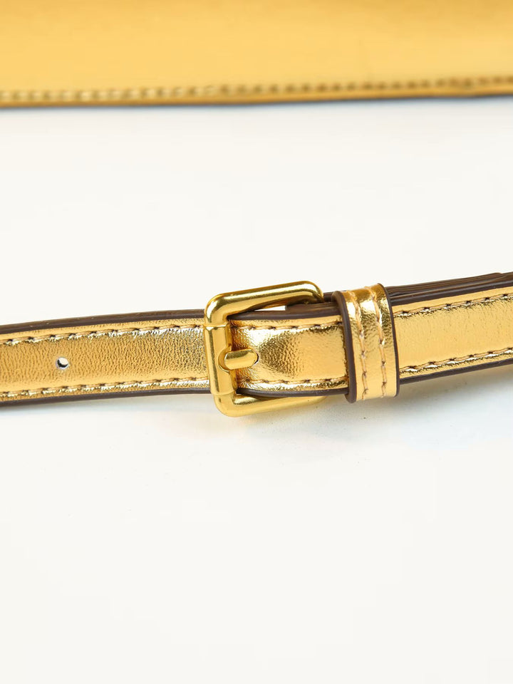Close-up of a metallic gold leather belt with a matching gold buckle, shown on a plain white background.