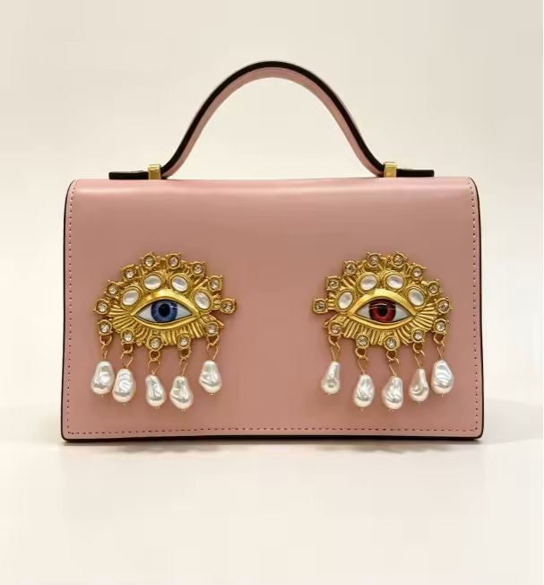 Compact square PU leather bag side view showing adjustable crossbody strap and structured body