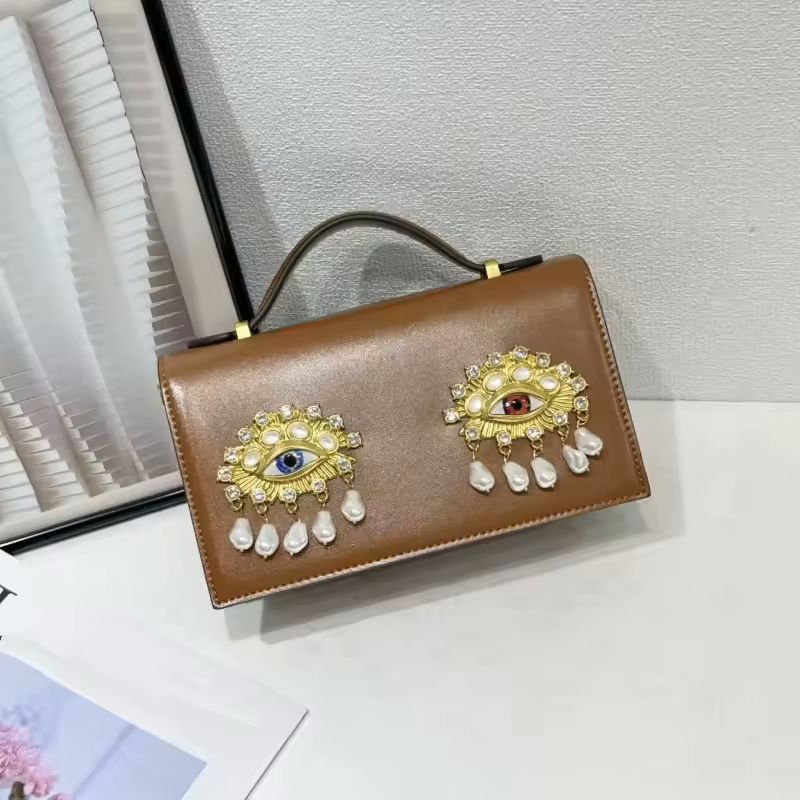 Black PU leather small square shoulder bag with 3D jewel eye close-up detail shot