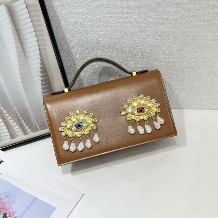 Black PU leather small square shoulder bag with 3D jewel eye close-up detail shot