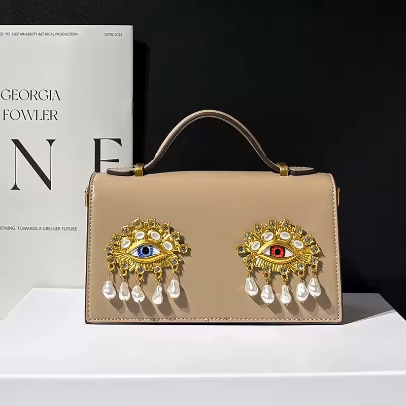 Namrico 3D eye crossbody bag lifestyle shot carried on shoulder showing compact everyday size