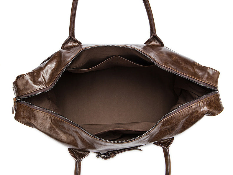 Brown leather bag with open top on a white background