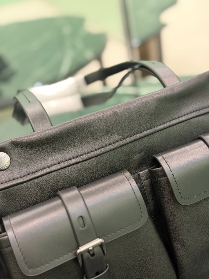 Dark leather structured bag with buckle pockets