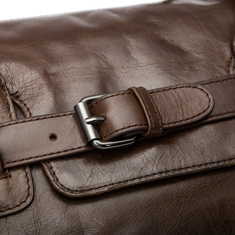 Close-up of a brown leather bag with a buckle