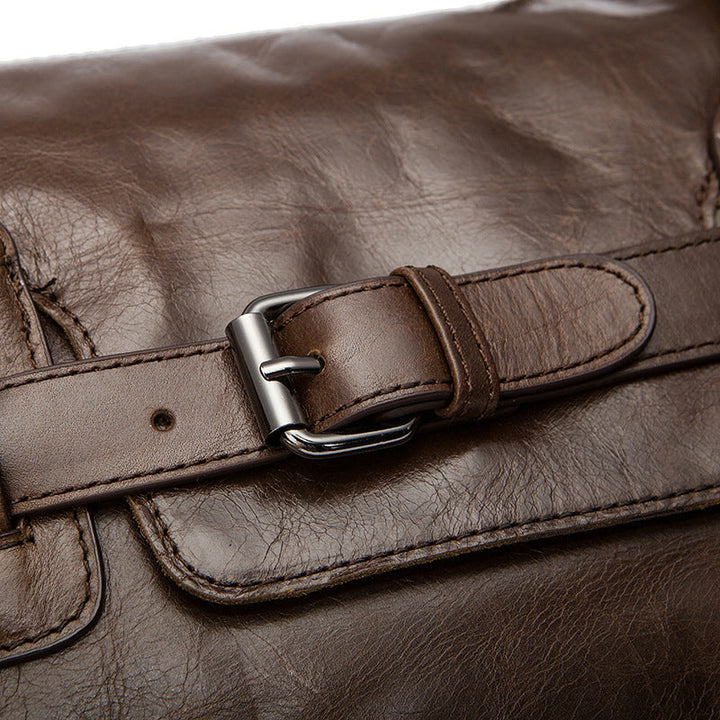 Close-up of a brown leather bag with a buckle