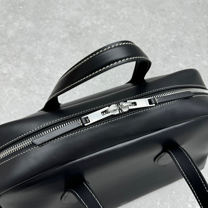 Large black leather carryall with silver clasp