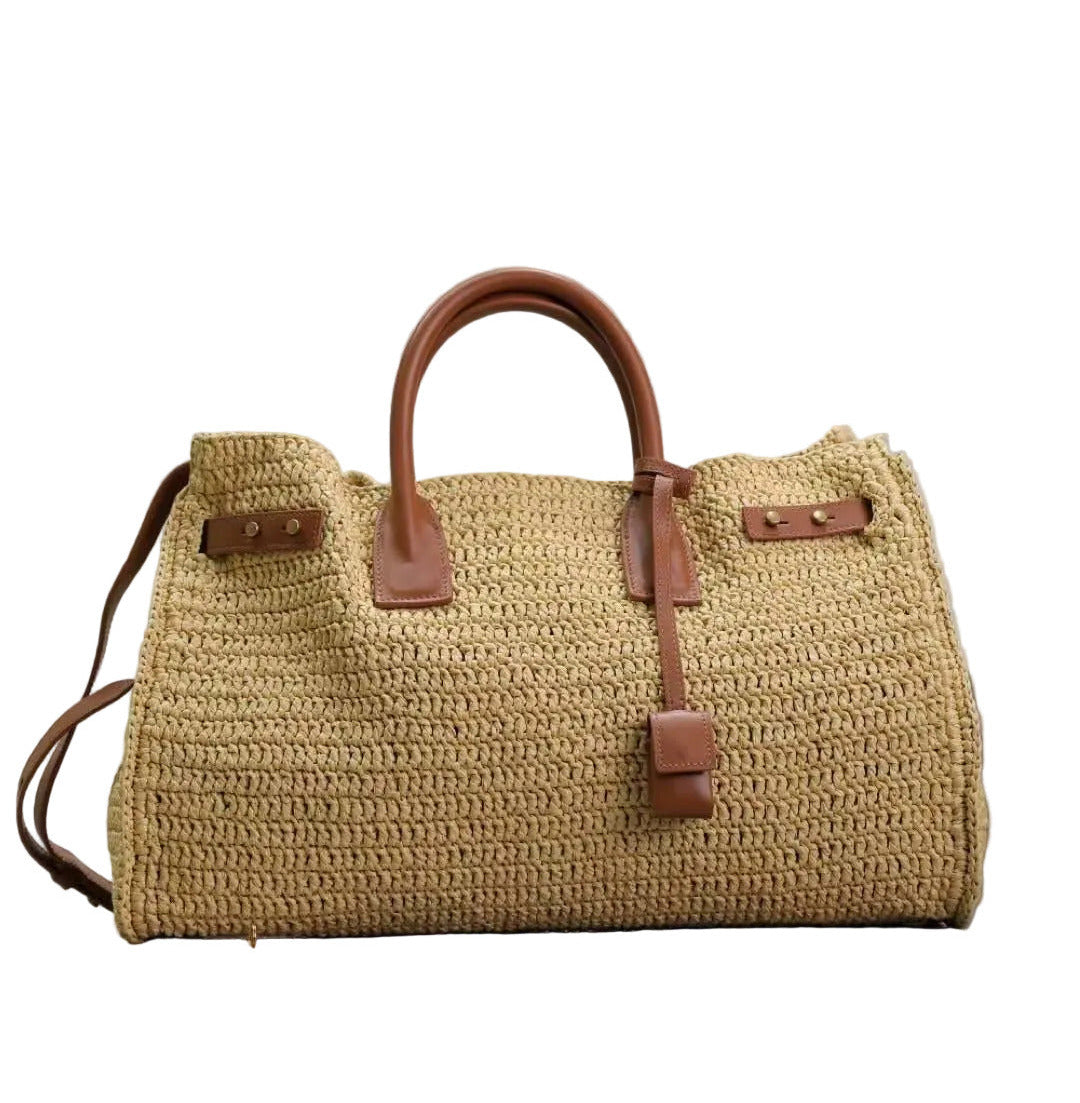 Woven handbag with brown leather straps on a white background