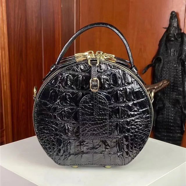 Genuine crocodile leather circular bag side view with crossbody strap detail