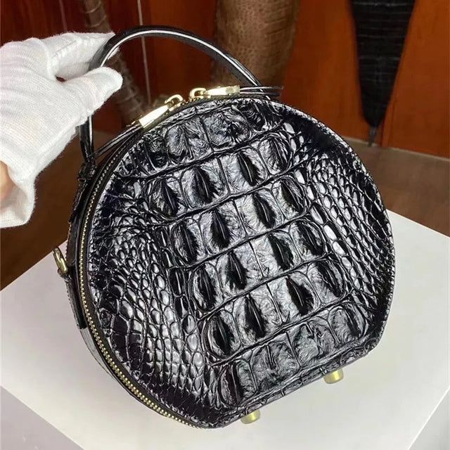 Black crocodile leather round handbag back view with adjustable strap