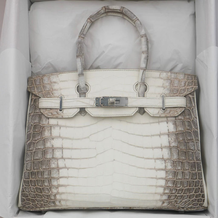 White handbag with brown crocodile leather trim in a box