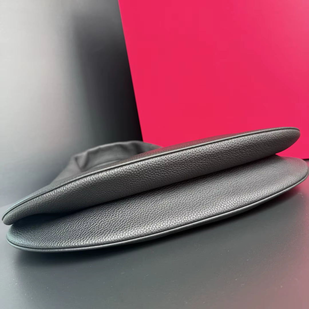 Two gray leather car seat covers on a reflective surface with a pink background