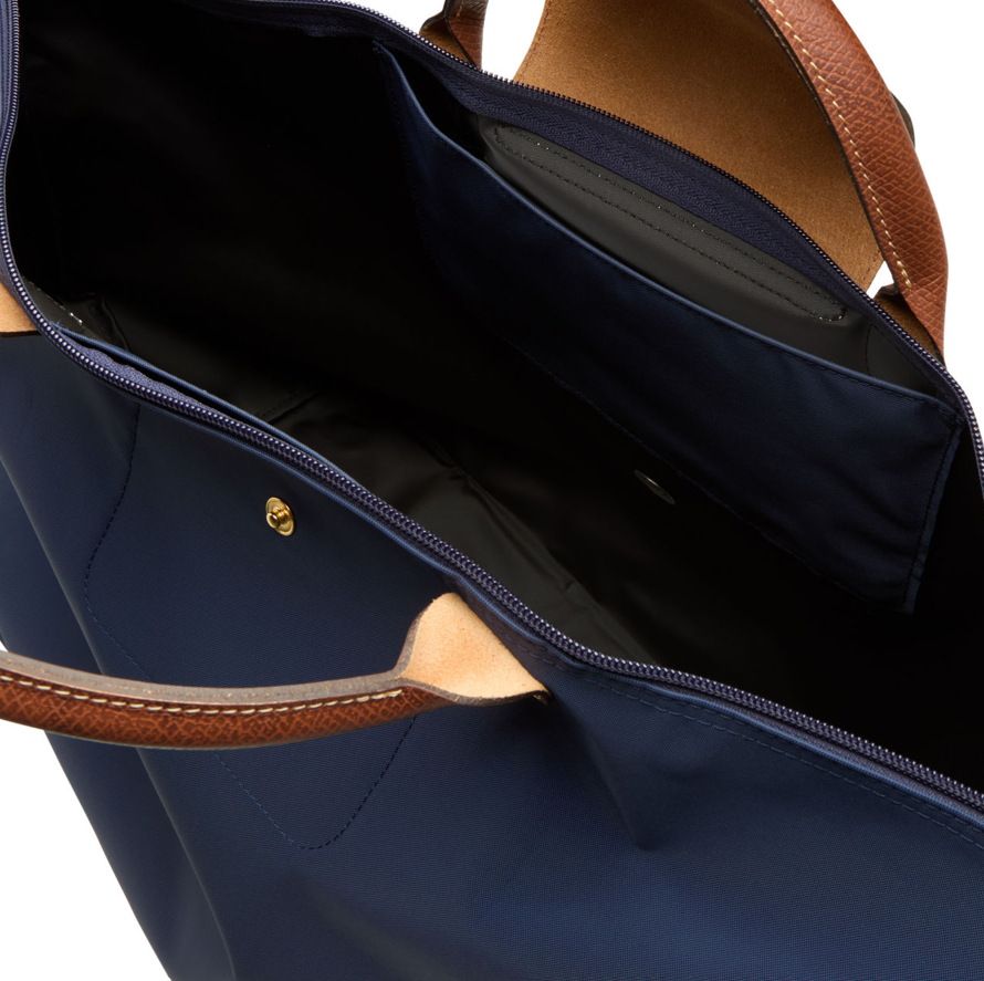 Navy tote bag with tan leather handles and trim