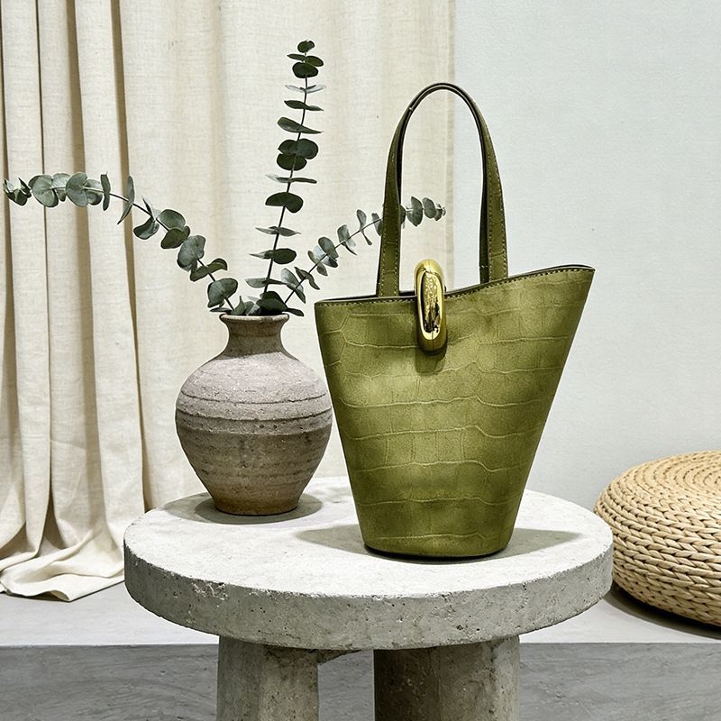 Asymmetric bucket handbag with topstitched details and dyed edges in olive green