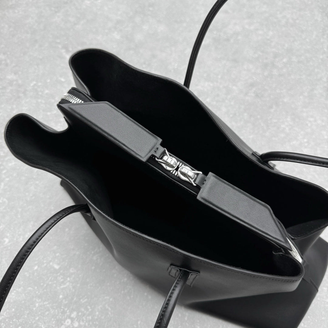 Contemporary arc design black leather handbag