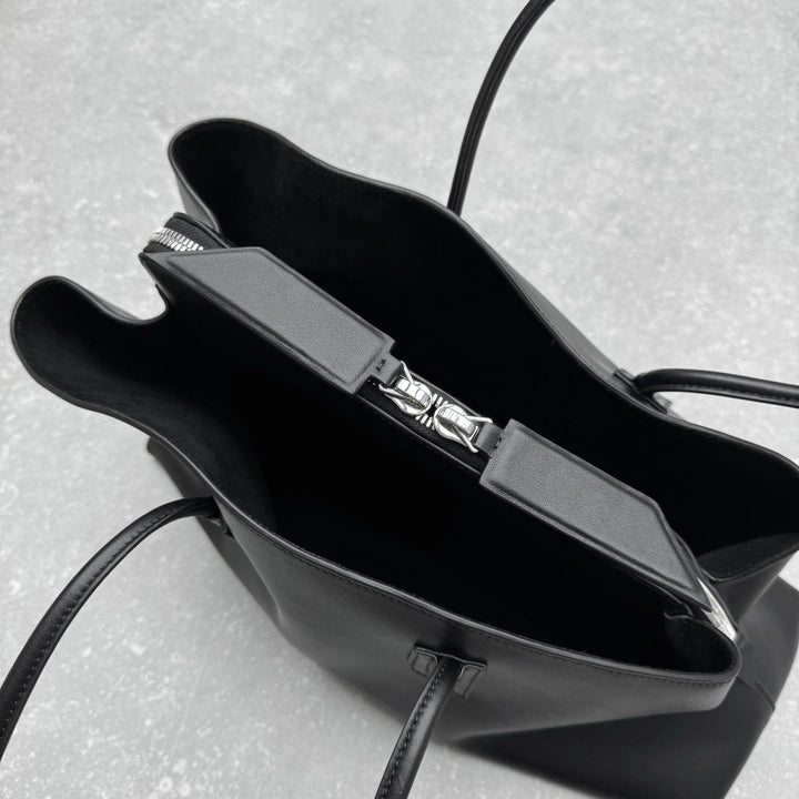 Contemporary arc design black leather handbag
