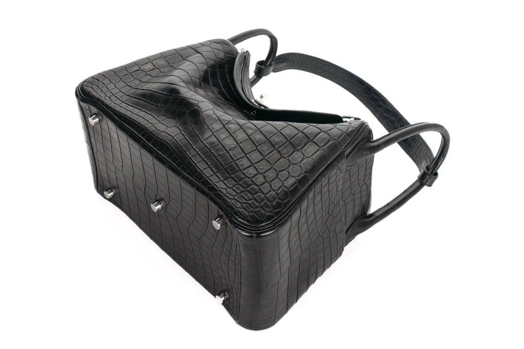 Black textured handbag on a white background