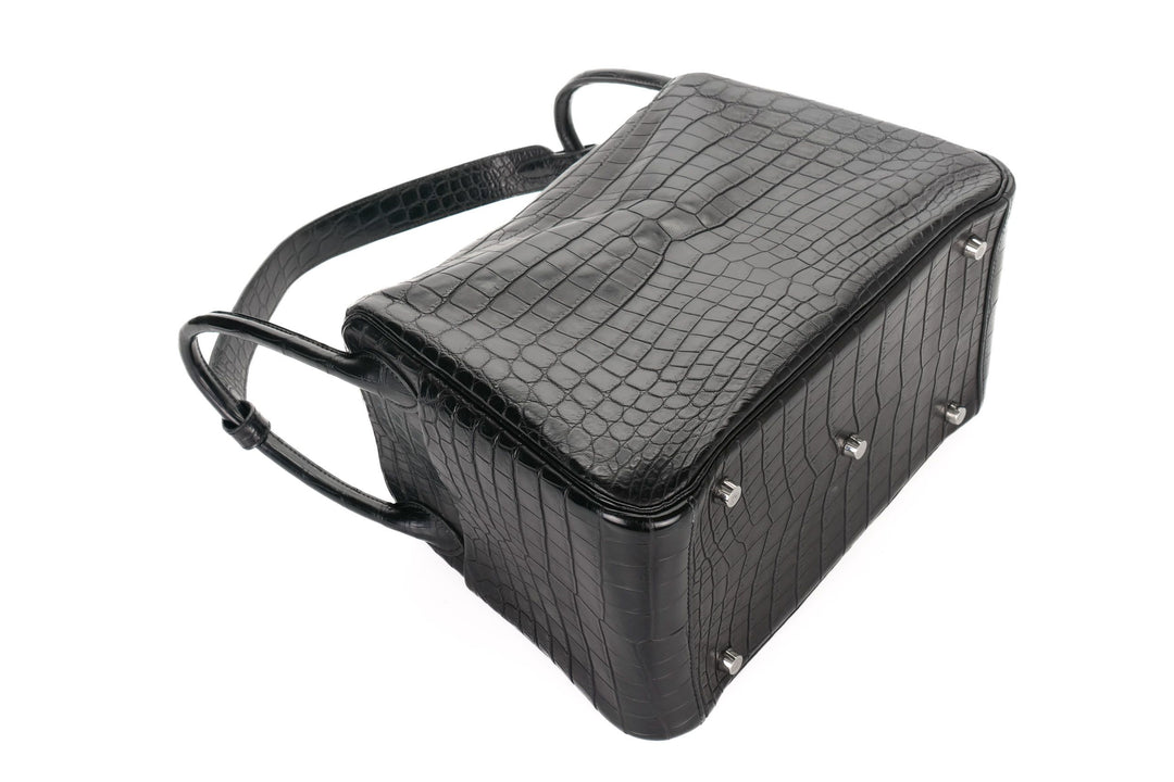 Black textured handbag with silver studs on a white background