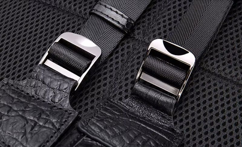Brown alligator-embossed flap backpack angle view showing laptop compartment depth and structure

