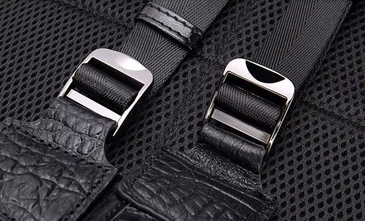 Brown alligator-embossed flap backpack angle view showing laptop compartment depth and structure

