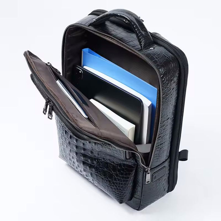Croc-embossed backpack top view showing dual zip pulls and padded top handle
