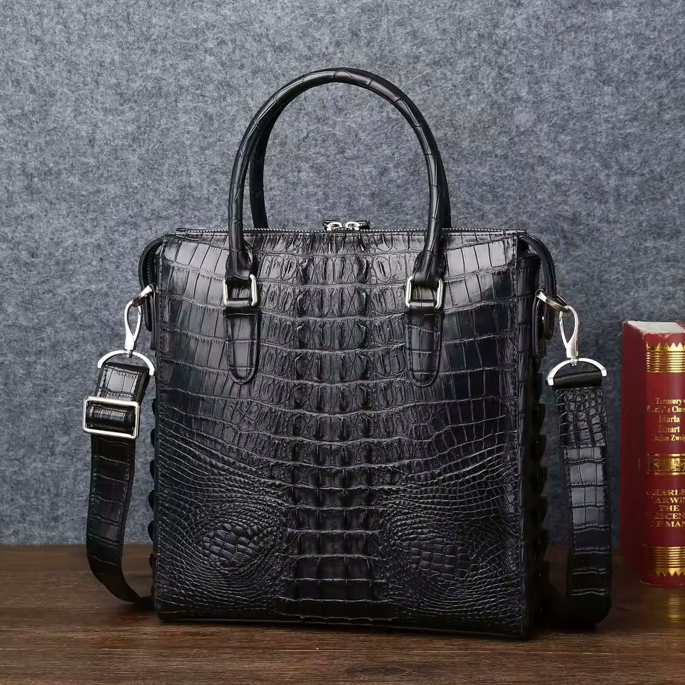 Croc-embossed leather briefcase front view showing 3D alligator head emboss and zip closure
